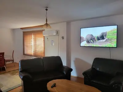 a living room with a couch and a flat screen tv at Villa Harmony in Bihać