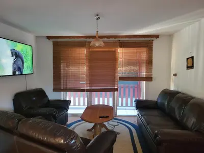 a living room with a leather couch and a table at Villa Harmony in Bihać