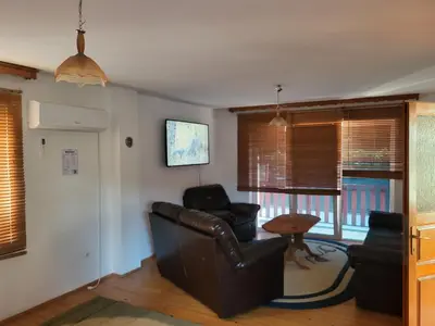 a living room with two chairs and a table at Villa Harmony in Bihać