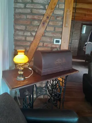 a table with a lamp and a briefcase on it at Vikendica Volar in Prijedor