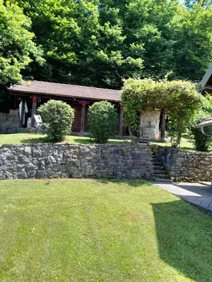a stone wall in front of a house at Vikendica Volar in Prijedor