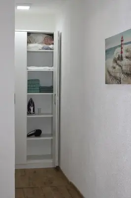 a hallway with a door open to a room at Blue Apartment in Bihać