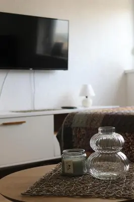 a glass jar on a table in a living room at Blue Apartment in Bihać