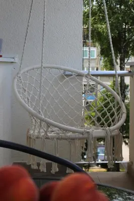 a white hanging basket with beads and strings at Blue Apartment in Bihać