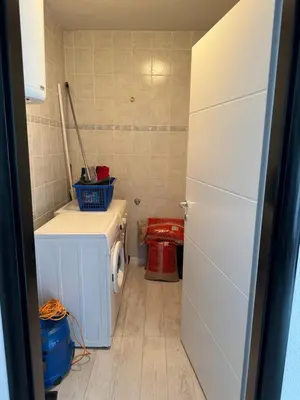 a small kitchen with a washer and dryer at Apartman Kumalic in Sanski most