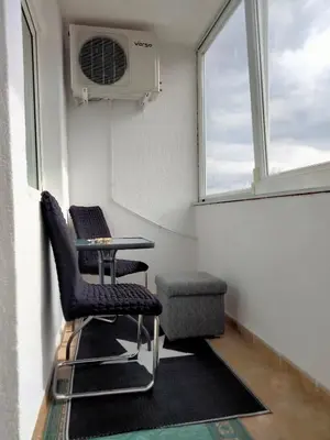 a room with two chairs and a table and a window at Apartman Kumalic in Sanski most