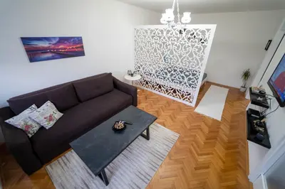 a living room with a couch and a table at Park Apartment in Visoko