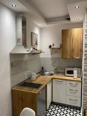 a small kitchen with a sink and a microwave at Apartman UNA-Plandište in Bihać
