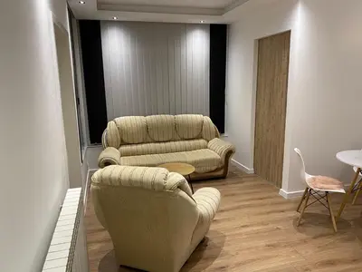 a living room with two chairs and a couch at Apartman UNA-Plandište in Bihać
