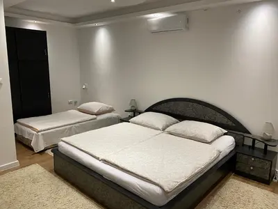 two beds in a bedroom with white walls at Apartman UNA-Plandište in Bihać