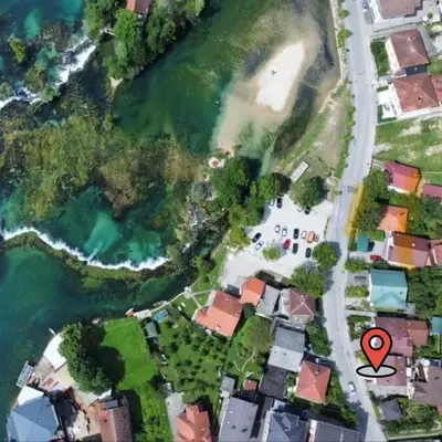 arial view of a suburb with a red marker at Apartman UNA-Plandište in Bihać