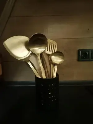 a black container filled with spoons and a fork at Stone Chalets - LUNA in Jajce