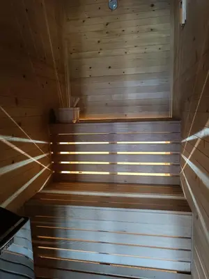 a sauna with wooden walls and a wooden stairs at Stone Chalets - LUNA in Jajce
