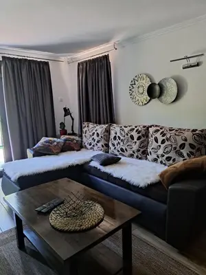 a living room with a couch and a table at Vikendica Bella in Bihać