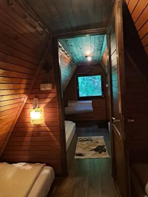 a small room with a bed and a tv at Vikendica Bella in Bihać