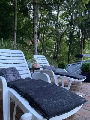 a group of white chairs sitting on a patio at Vikendica Bella in Bihać