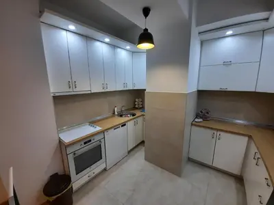 a kitchen with white cabinets and a sink at IGX in Banja Luka
