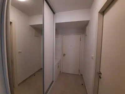 a hallway with a mirror and a white door at IGX in Banja Luka