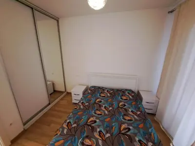 a bedroom with a bed with a colorful blanket at IGX in Banja Luka