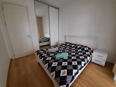 a bedroom with a black and white bed and a mirror at IGX in Banja Luka