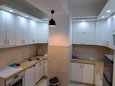 a kitchen with white cabinets and a sink at IGX in Banja Luka