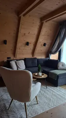 a living room with a blue couch and a table at Stone Chalets - TERRA in Jajce