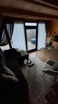 a living room with a couch and a large window at Stone Chalets - TERRA in Jajce