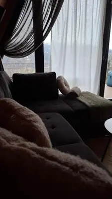 a living room with a couch and a window at Stone Chalets - TERRA in Jajce