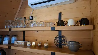 a shelf with glasses and other items on it at Stone Chalets - TERRA in Jajce