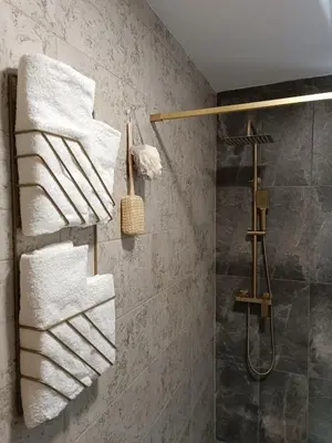 a bathroom with white towels hanging on a wall at Stone Chalets - TERRA in Jajce