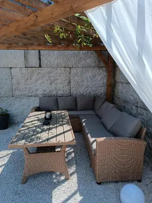 a patio with a couch and a table at Stone Chalets - TERRA in Jajce