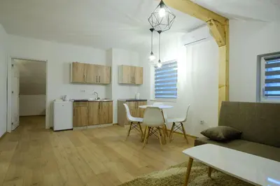 a kitchen and living room with a table and chairs at Unique Apartments Visoko in Visoko