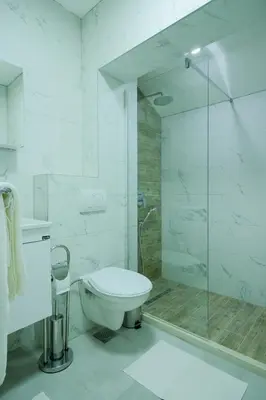 a bathroom with a toilet and a glass shower at Unique Apartments Visoko in Visoko
