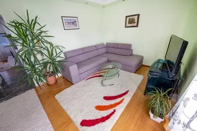 a living room with a couch and a rug at Spacious apartment (60sqm) with a balcony in Tuzla