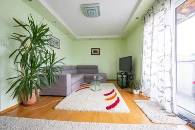 a living room with a couch and a tv at Spacious apartment (60sqm) with a balcony in Tuzla