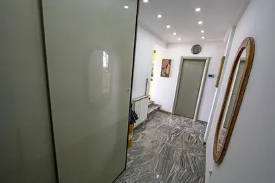 a hallway with a door leading to a room at Spacious apartment (60sqm) with a balcony in Tuzla