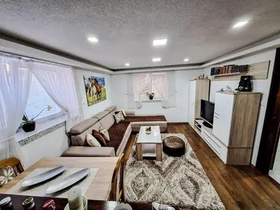 a living room with a couch and a refrigerator at Apartman Magic Sauna,Jakuzzi,Kino in Livno