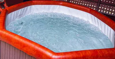 a pool of water in a red plastic tub at Apartman Magic Sauna,Jakuzzi,Kino in Livno