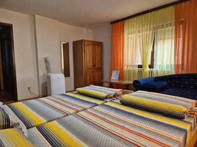 a bedroom with two beds and a window at City Center Stay in Visoko