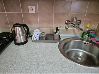 a kitchen counter with a sink and a coffee maker at City Center Stay in Visoko