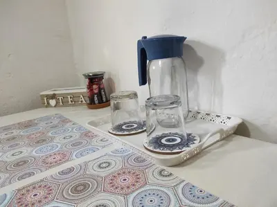a blender and two glasses sitting on a counter at City Center Stay in Visoko