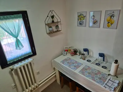 a small table in a room with a window at City Center Stay in Visoko