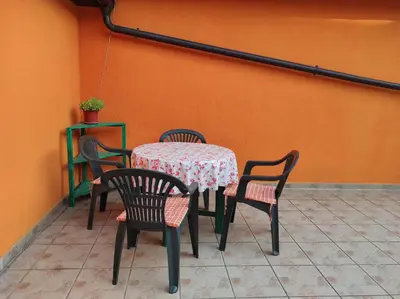 a table with chairs and a table and a table and chairs at City Center Stay in Visoko