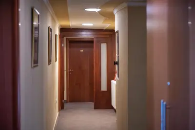 a hallway with a wooden door in a room at Rio apartments in Banja Luka