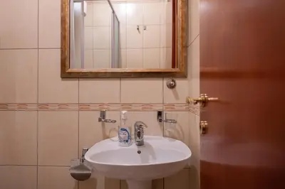 a bathroom with a white sink and a mirror at Rio apartments in Banja Luka