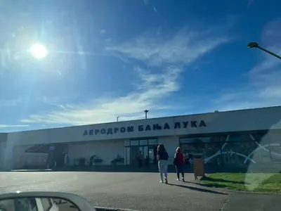 two people walking in front of a building at Apartmani Golubina - Trn, Laktasi, BANJA LUKA in Grabljani