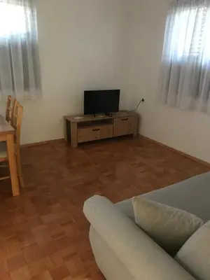a living room with a couch and a flat screen tv at Apartmani Golubina - Trn, Laktasi, BANJA LUKA in Grabljani