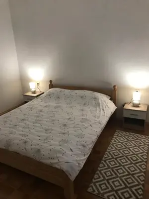 a bedroom with a bed and two lamps on two tables at Apartmani Golubina - Trn, Laktasi, BANJA LUKA in Grabljani