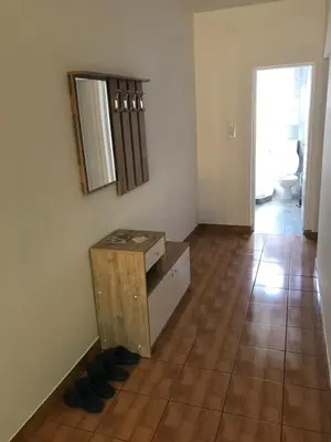 a room with a table and a mirror on the wall at Apartmani Golubina - Trn, Laktasi, BANJA LUKA in Grabljani