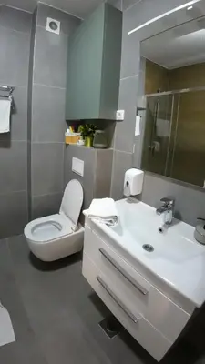 a bathroom with a white toilet and a sink at Apartman Ana in Banja Luka